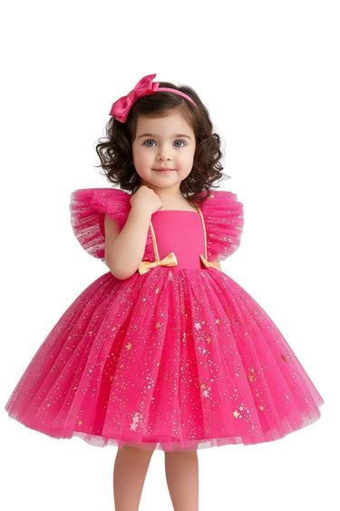 Young girl wearing a pink dress with star details on a white background